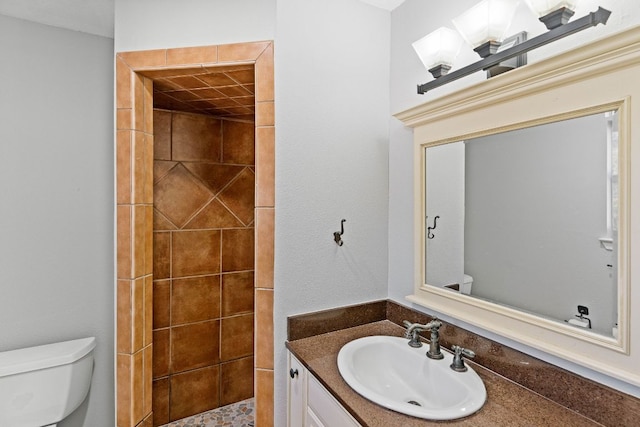 7701 Penelope Cir, Austin, TX 78759 - bathroom with a tile shower, vanity, and toilet