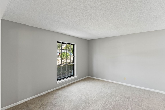 7701 Penelope Cir, Austin, TX 78759 - spare room featuring carpet, a textured ceiling, and baseboards
