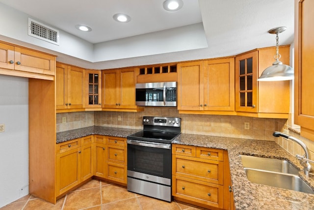 7701 Penelope Cir, Austin, TX 78759 - kitchen with stainless steel appliances, brown cabinets, visible vents, and a sink