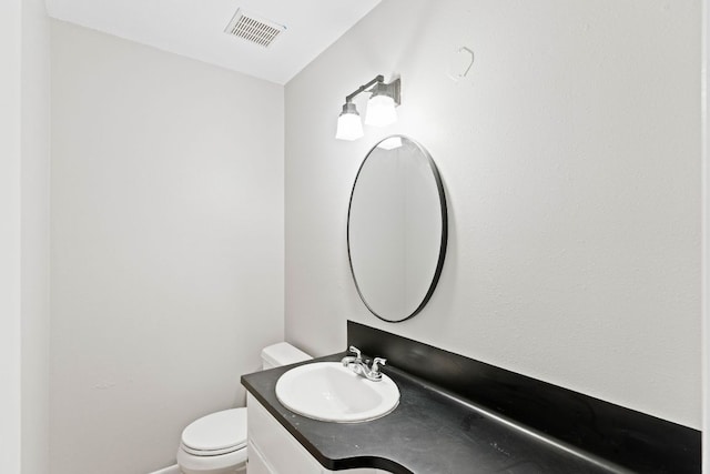 7701 Penelope Cir, Austin, TX 78759 - half bathroom featuring toilet, vanity, and visible vents