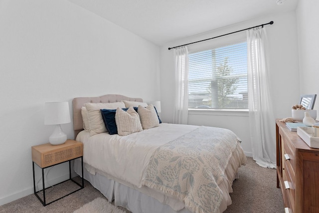 carpeted bedroom with baseboards