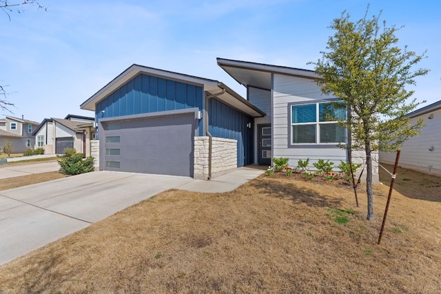 view of front of home featuring an attached garage, board and batten siding, and concrete driveway