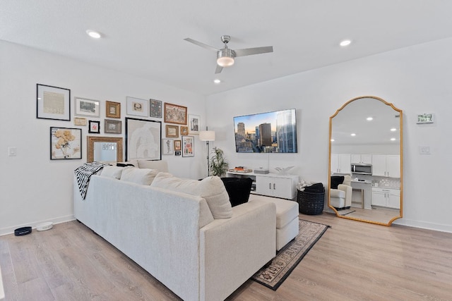 living room featuring ceiling fan, recessed lighting, light wood-type flooring, and baseboards