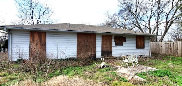 back of house featuring fence