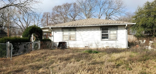 view of side of home featuring fence