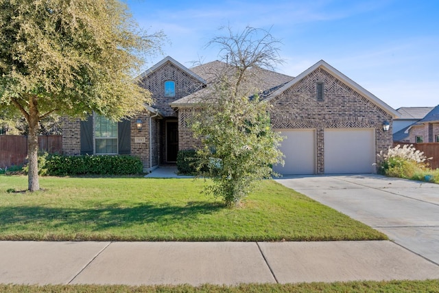 view of front of house featuring brick siding, an attached garage, a front yard, fence, and driveway