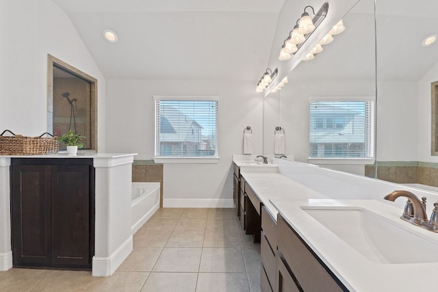 bathroom featuring lofted ceiling, tile patterned flooring, plenty of natural light, and a sink