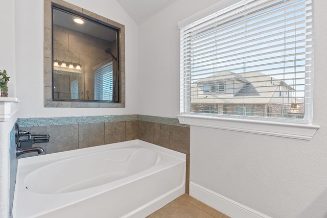 bathroom featuring baseboards, walk in shower, a garden tub, and tile patterned floors