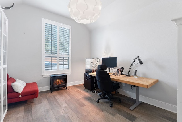 office area featuring lofted ceiling, wood finished floors, and baseboards