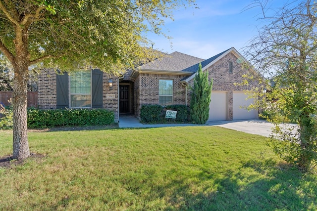 view of front of home with a garage, a shingled roof, concrete driveway, a front lawn, and brick siding