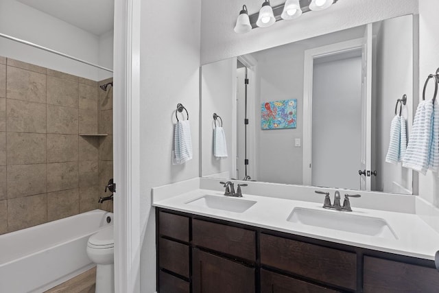 full bathroom with shower / washtub combination, a sink, toilet, and double vanity