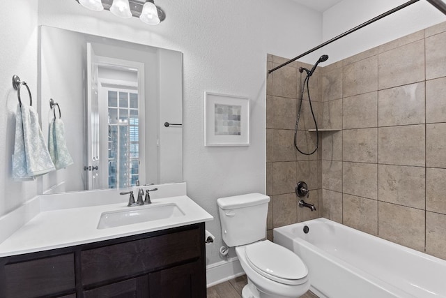 full bathroom with toilet, shower / tub combination, baseboards, and vanity