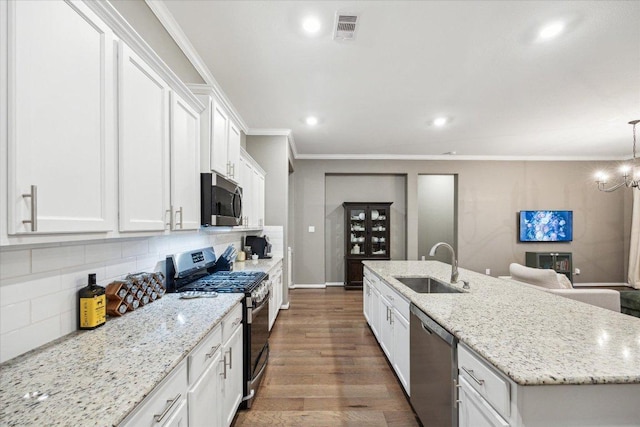 kitchen featuring crown molding, visible vents, appliances with stainless steel finishes, white cabinetry, and a sink