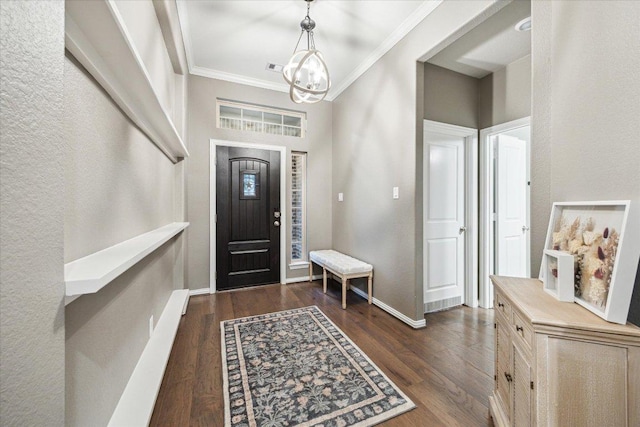 foyer entrance with baseboards, ornamental molding, a chandelier, and dark wood-type flooring