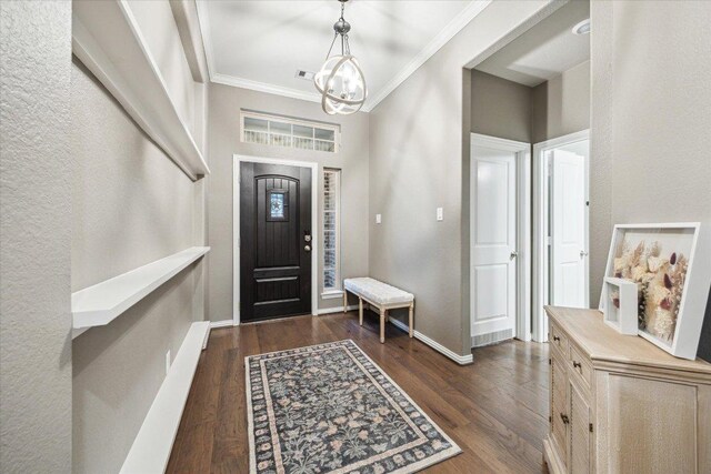 6618 Tiger Trl, Katy, TX 77493 - foyer featuring a chandelier, crown molding, dark wood-type flooring, and baseboards