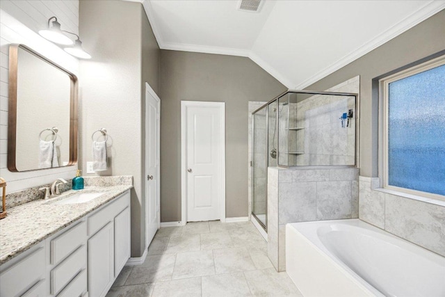 bathroom with a garden tub, ornamental molding, vaulted ceiling, a shower stall, and vanity