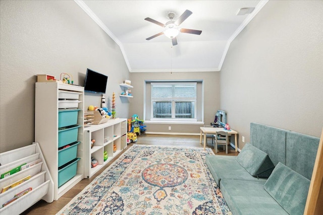 game room featuring lofted ceiling, ornamental molding, and wood finished floors