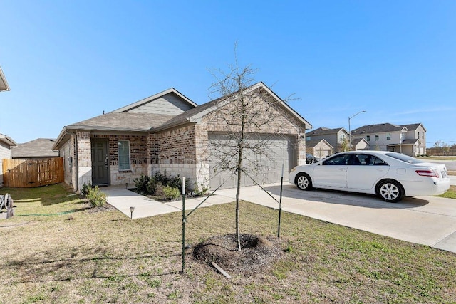 ranch-style house featuring a garage, brick siding, fence, driveway, and a front lawn