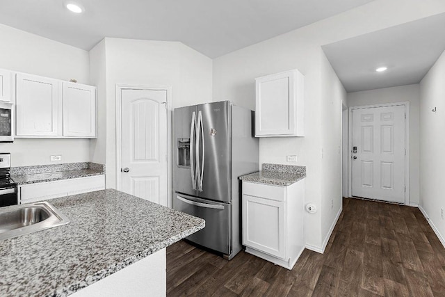 kitchen featuring baseboards, dark wood finished floors, white microwave, white cabinetry, and stainless steel refrigerator with ice dispenser