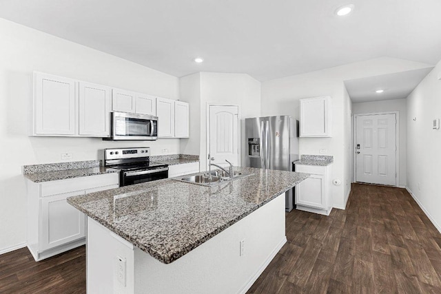 kitchen with light stone counters, stainless steel appliances, and dark wood-type flooring