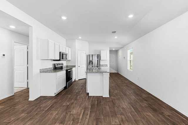 kitchen featuring appliances with stainless steel finishes, a kitchen island with sink, dark wood-style flooring, and white cabinets