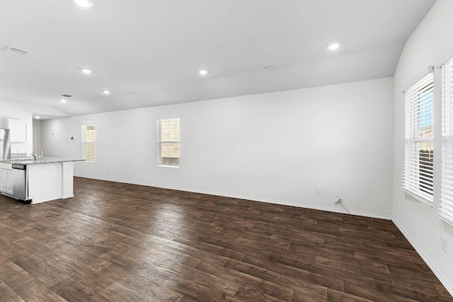 unfurnished living room with dark wood-style floors, visible vents, and recessed lighting