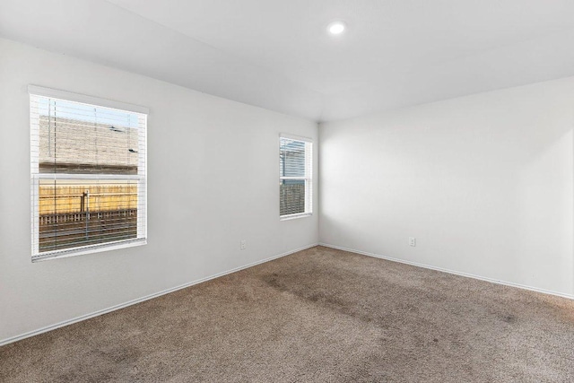 empty room with baseboards, carpet floors, and recessed lighting