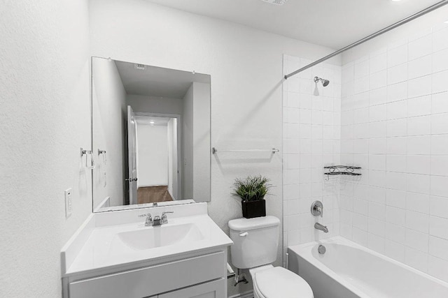 bathroom featuring shower / tub combination, vanity, and toilet