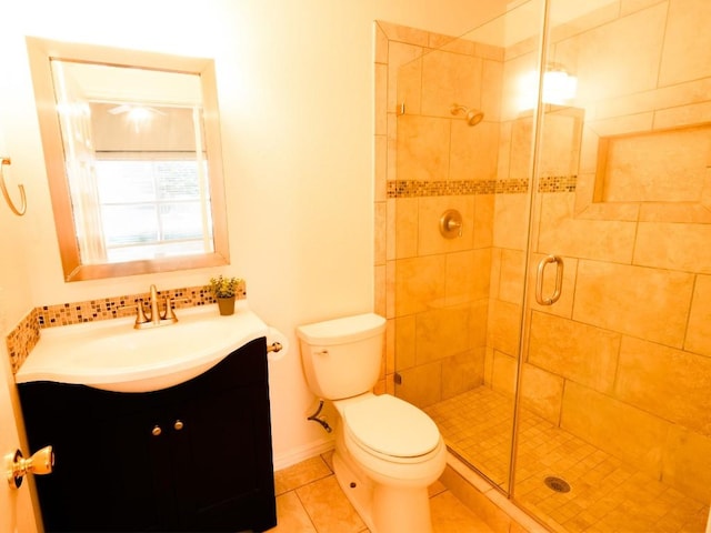 full bathroom featuring a stall shower, baseboards, toilet, tile patterned flooring, and vanity