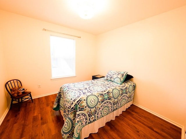 bedroom with wood finished floors and baseboards