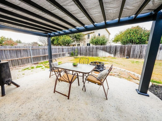 view of patio / terrace with a fenced backyard, a pergola, and outdoor dining space