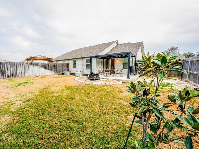 back of house featuring a yard, a fenced backyard, and a patio