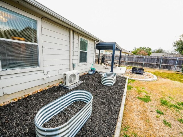 view of yard with ac unit, a patio area, fence, and an outdoor fire pit