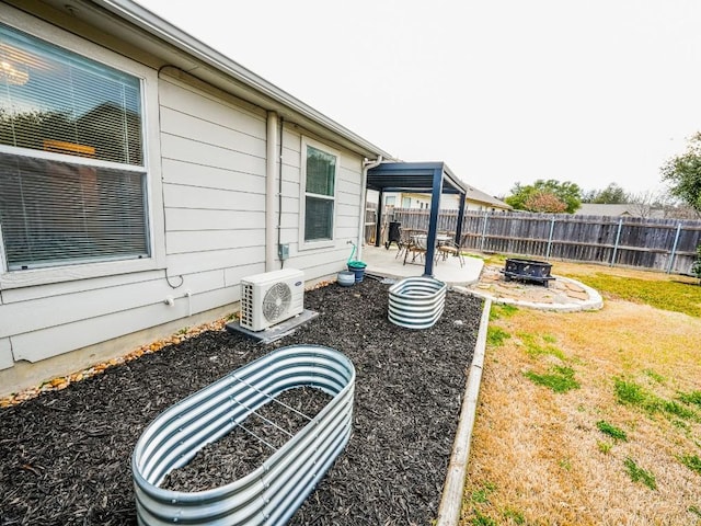 view of yard with a patio, a fire pit, ac unit, and a fenced backyard