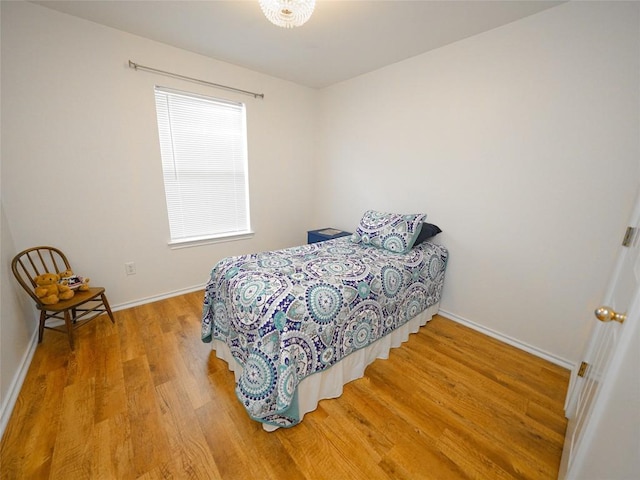 bedroom with baseboards and light wood-type flooring
