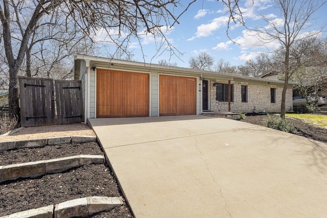 ranch-style house featuring driveway and an attached garage