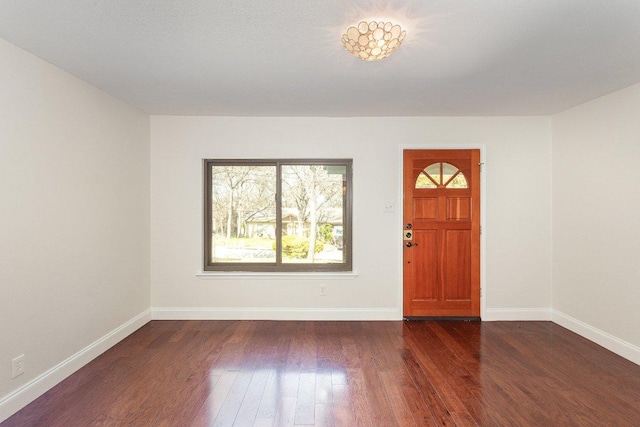 entrance foyer featuring dark wood-style floors and baseboards