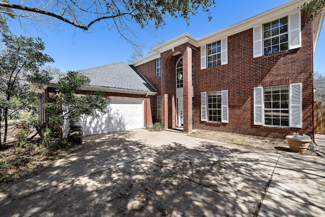 view of front facade featuring a garage, brick siding, driveway, and a shingled roof