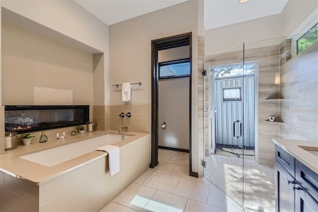 bathroom featuring vanity, tile patterned flooring, a shower stall, and a bath