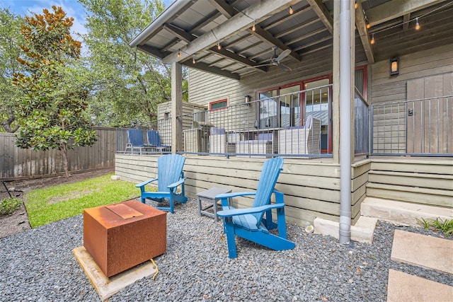 view of patio featuring a ceiling fan and fence