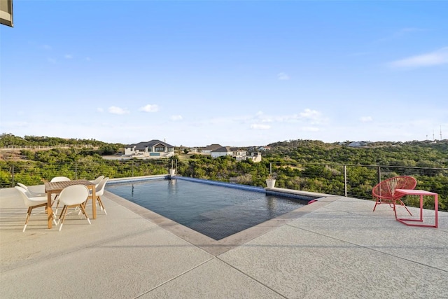 view of swimming pool with a fenced in pool and a patio