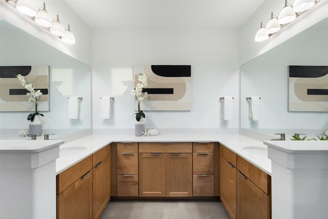 bathroom with two vanities, a sink, and tile patterned floors