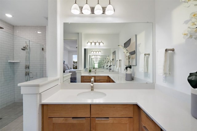 ensuite bathroom featuring vanity, a stall shower, and ensuite bathroom