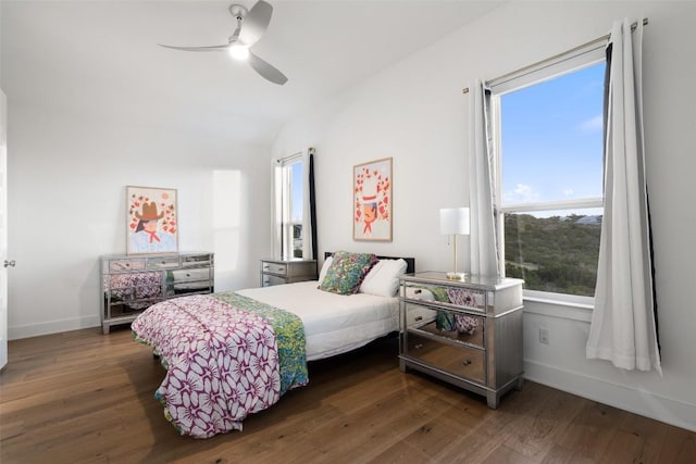 bedroom featuring vaulted ceiling, ceiling fan, baseboards, and wood finished floors