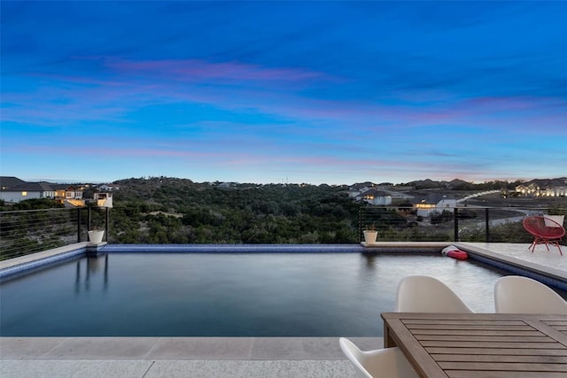 view of swimming pool with an infinity pool