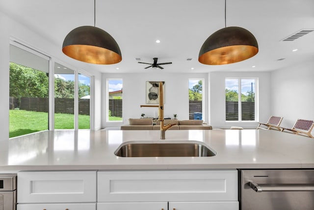 kitchen featuring recessed lighting, visible vents, hanging light fixtures, open floor plan, and white cabinets