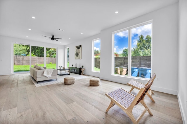 living room featuring visible vents, baseboards, light wood-style flooring, and recessed lighting