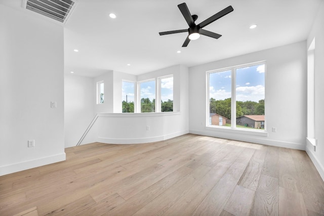 spare room with light wood-style flooring, visible vents, baseboards, and recessed lighting