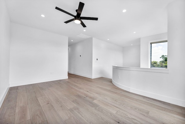 unfurnished room with recessed lighting, visible vents, light wood-style flooring, a ceiling fan, and baseboards