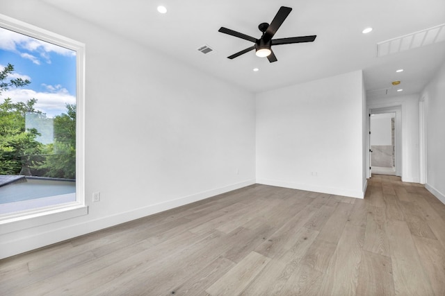 unfurnished room with light wood-type flooring, visible vents, baseboards, and recessed lighting